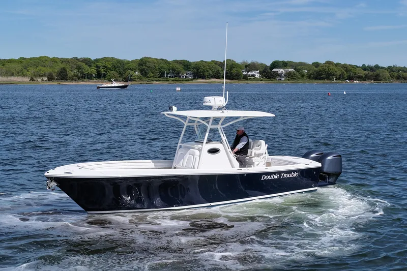 Slide: The Image of 2019 Regulator 28 Forward Seating boat cruising on a calm lake. - 3