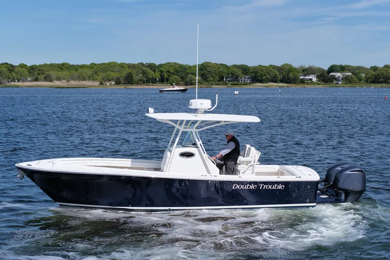 Slide: The Image of 2019 Regulator 28 Forward Seating boat cruising on a scenic lake. - 4