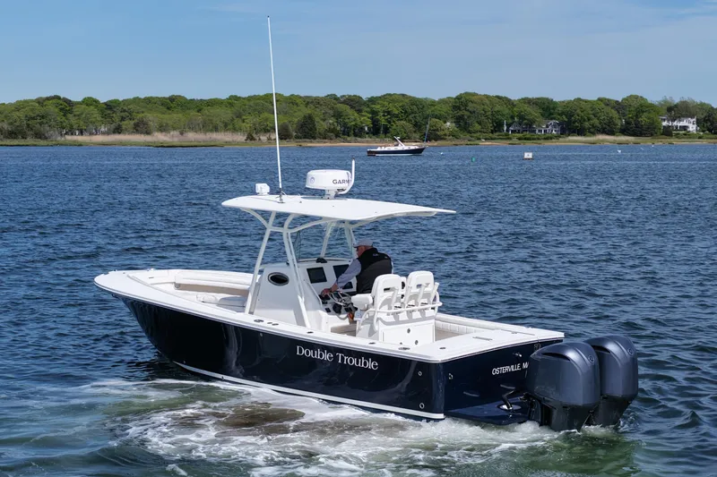 Slide: The Image of 2019 Regulator 28 Forward Seating boat cruising on a calm lake. - 5