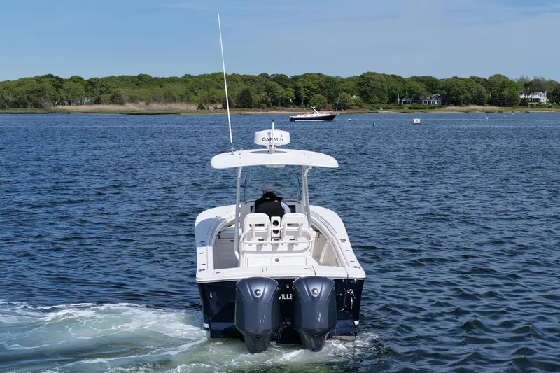 Slide: The Image of 2019 Regulator 28 Forward Seating boat cruising on a calm lake. - 6