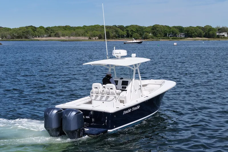 Slide: The Image of 2019 Regulator 28 Forward Seating boat cruising on a calm lake. - 7