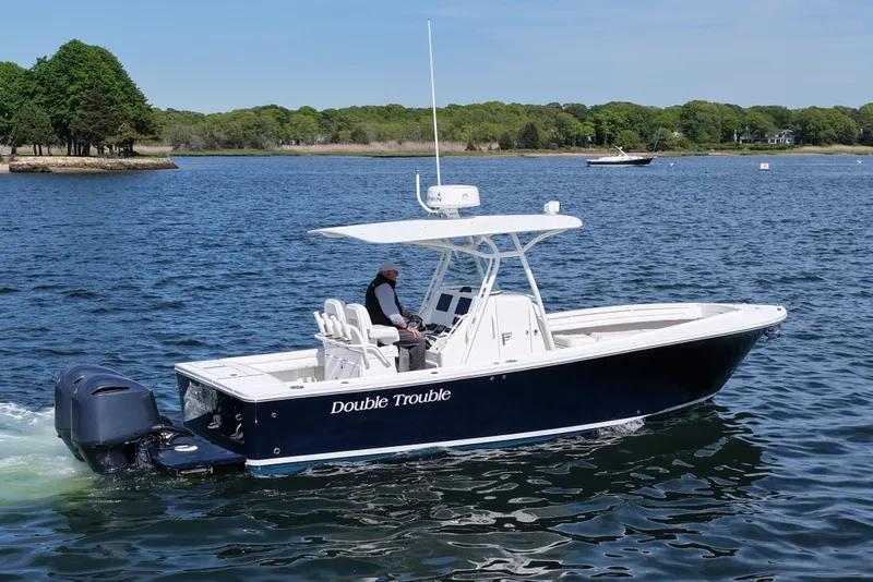 Slide: The Image of 2019 Regulator 28 Forward Seating boat cruising on a scenic lake. - 8