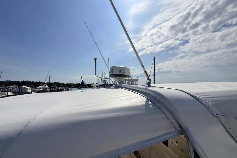 Slide: The Image of 1995 Tiara Yachts 4000 Express on a sunny day, showcasing sleek design and marina backdrop. - 12
