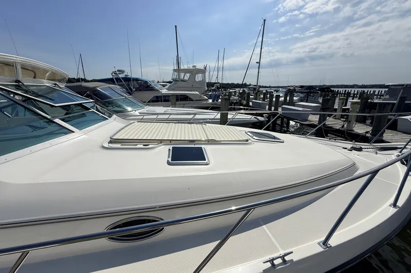 Slide: The Image of 1995 Tiara Yachts 4000 Express docked at marina under clear sky. - 14