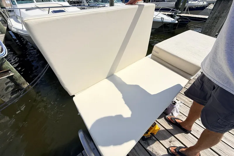 Slide: The Image of 1995 Tiara Yachts 4000 Express, dockside seating area with white cushions. - 16