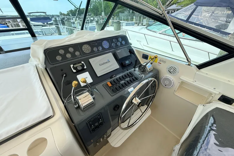 Slide: The Image of 1995 Tiara Yachts 4000 Express helm with Garmin navigation system and control panel. - 21