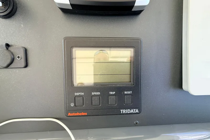 Slide: The Image of Autopilot display on 1995 Tiara Yachts 4000 Express dashboard, showing depth, speed, and trip data. - 22