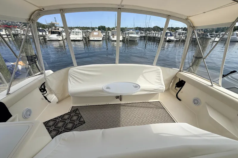 Slide: The Image of 1995 Tiara Yachts 4000 Express interior with white seating, marina view. - 27