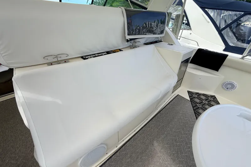 Slide: The Image of Interior of a 1995 Tiara Yachts 4000 Express, featuring white seating and modern amenities. - 29