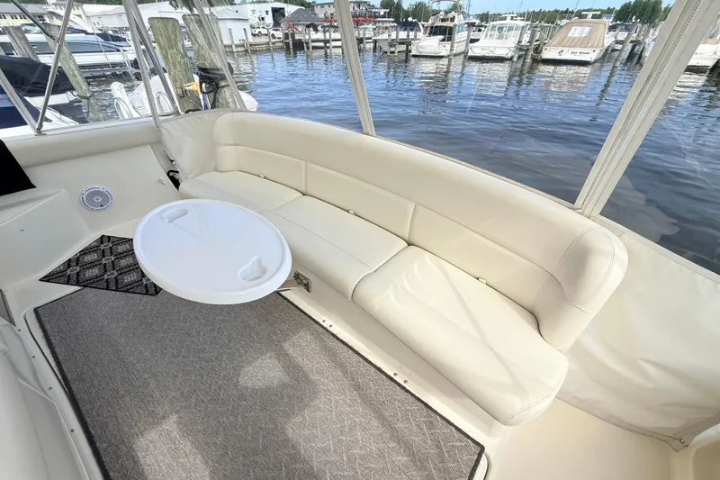 Slide: The Image of Luxurious seating area on a 1995 Tiara Yachts 4000 Express, docked at a marina. - 31