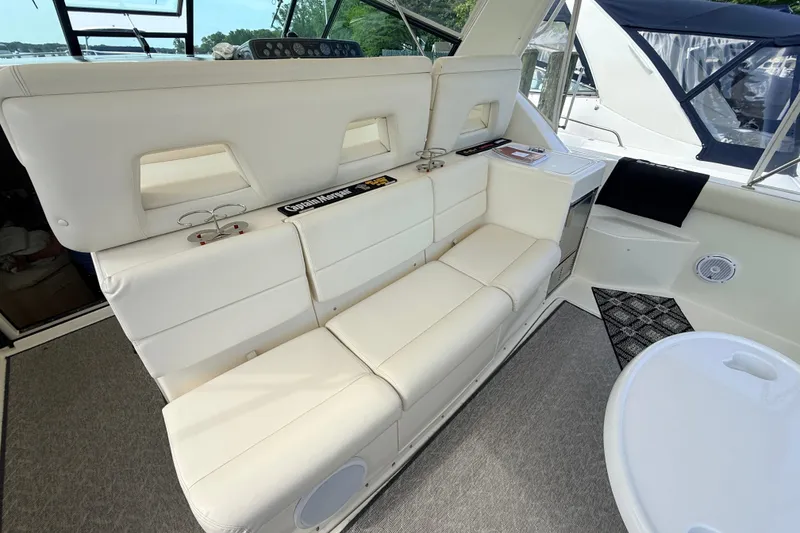 Slide: The Image of 1995 Tiara Yachts 4000 Express interior with white seating and modern amenities. - 32