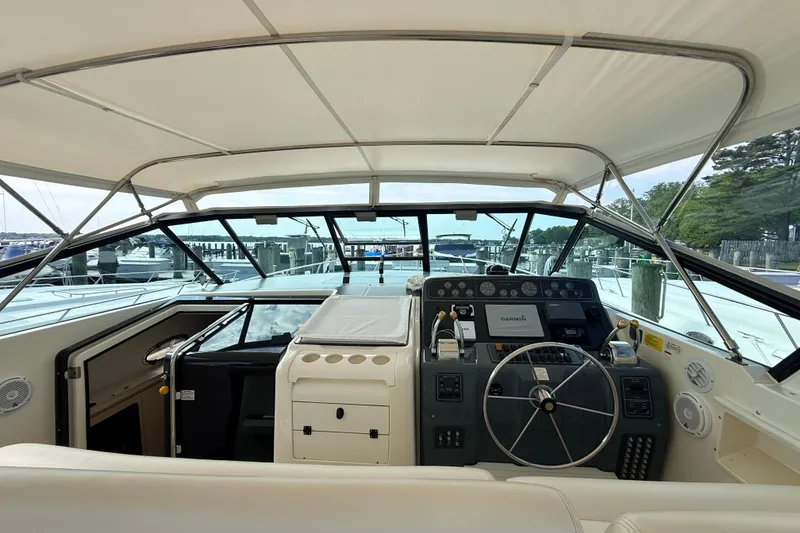 Slide: The Image of 1995 Tiara Yachts 4000 Express cockpit with steering wheel and navigation controls. - 33