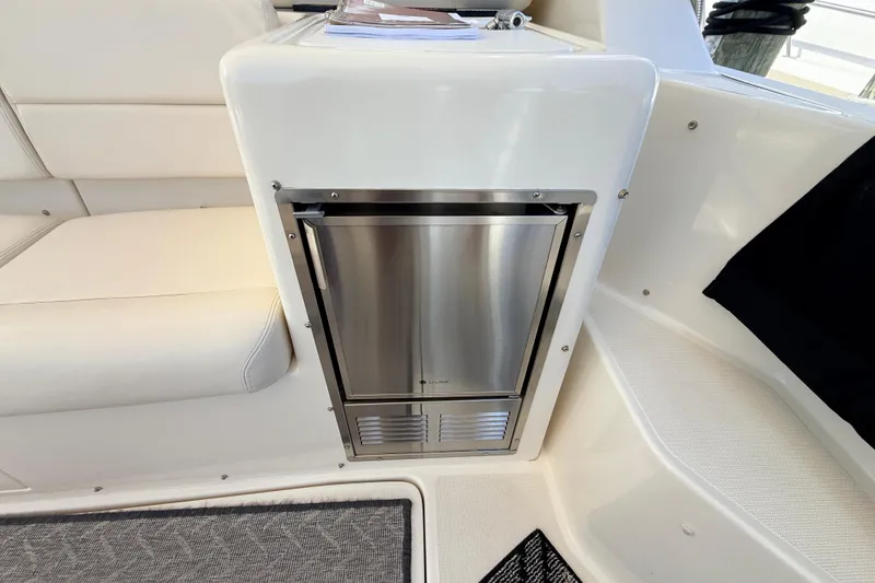 Slide: The Image of Stainless steel appliance on 1995 Tiara Yachts 4000 Express interior, featuring white seating. - 34