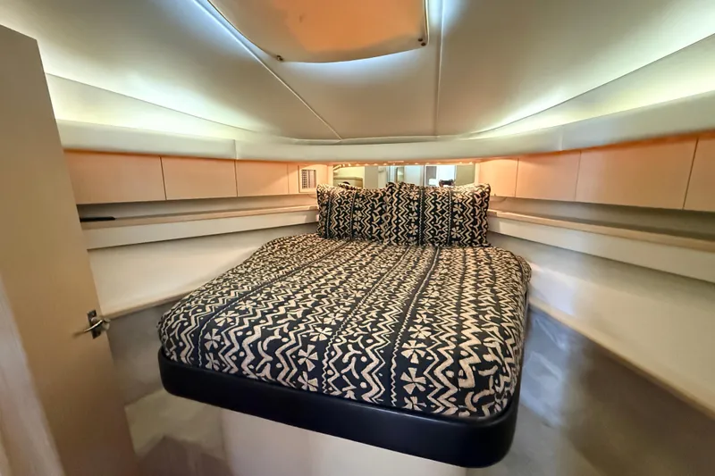 Slide: The Image of 1995 Tiara Yachts 4000 Express cabin with patterned bedding and modern interior design. - 35