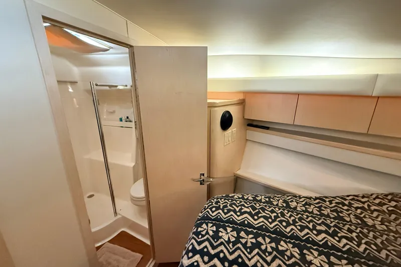 Slide: The Image of 1995 Tiara Yachts 4000 Express interior with bathroom and cozy sleeping area. - 37