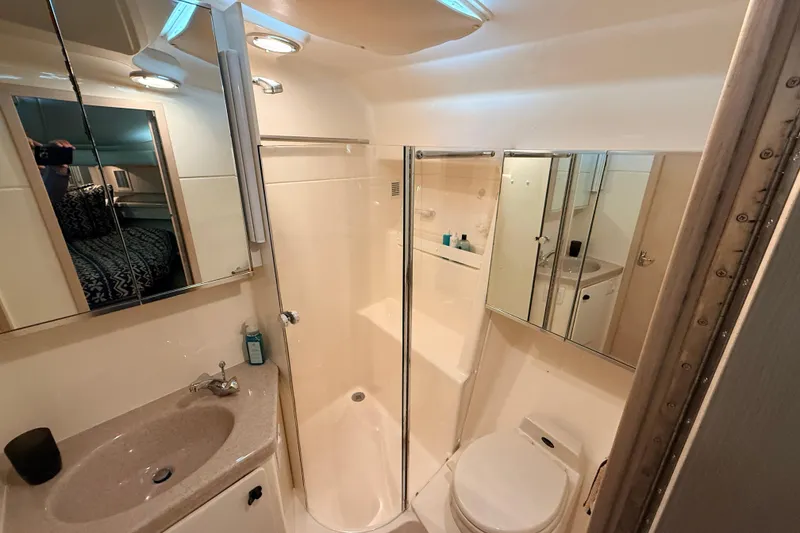Slide: The Image of Bathroom interior of 1995 Tiara Yachts 4000 Express, featuring sink, toilet, and shower. - 38