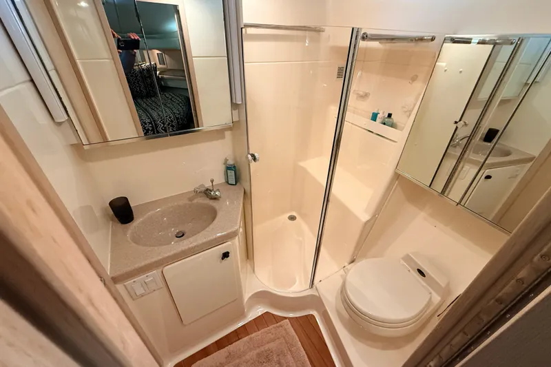 Slide: The Image of Bathroom interior of 1995 Tiara Yachts 4000 Express, featuring sink, shower, and toilet. - 39