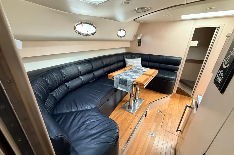 Slide: The Image of Luxurious interior of a 1995 Tiara Yachts 4000 Express with leather seating and wooden table. - 40