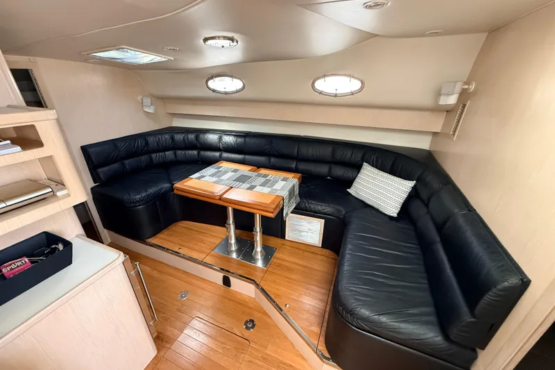 Slide: The Image of Luxurious interior of 1995 Tiara Yachts 4000 Express with leather seating and wooden table. - 46