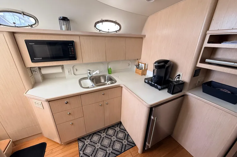 Slide: The Image of 1995 Tiara Yachts 4000 Express kitchen with microwave, sink, and coffee maker. - 47