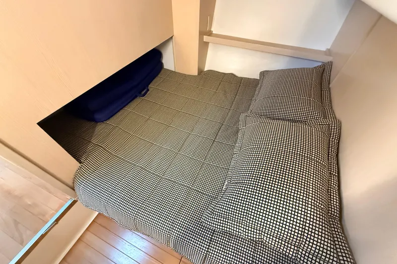 Slide: The Image of Cozy cabin bed in 1995 Tiara Yachts 4000 Express with checkered bedding. - 50