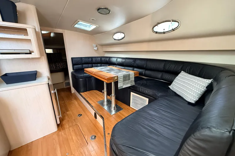 Slide: The Image of Interior of 1995 Tiara Yachts 4000 Express with leather seating and wooden table. - 53