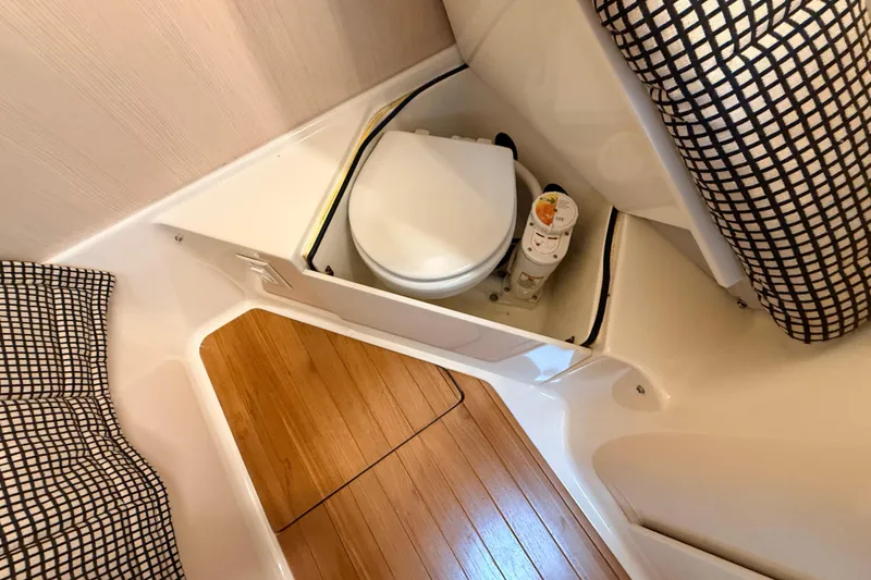 Slide: The Image of 1995 Tiara Yachts 4000 Express bathroom with wooden flooring and compact toilet. - 54