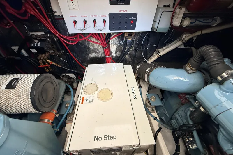 Slide: The Image of Engine room of a 1995 Tiara Yachts 4000 Express, featuring wiring and machinery components. - 56