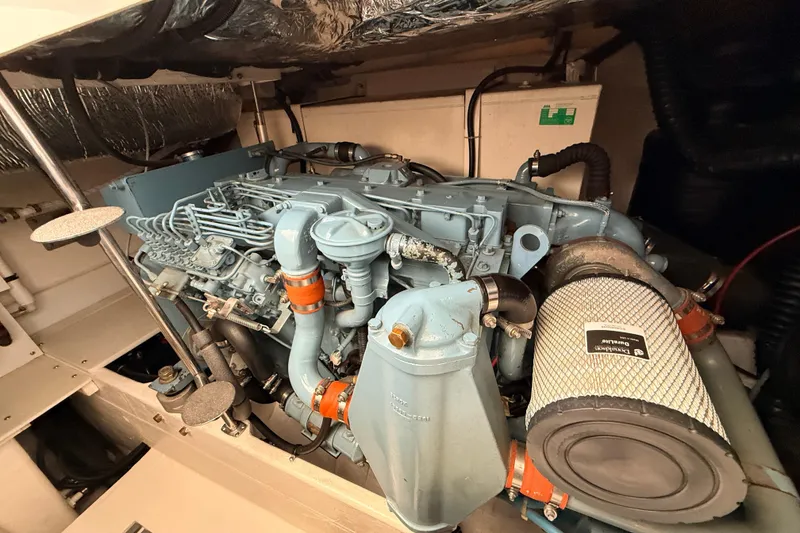 Slide: The Image of Engine compartment of a 1995 Tiara Yachts 4000 Express, showcasing detailed machinery. - 58