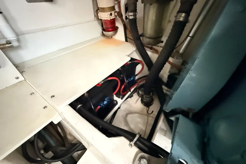 Slide: The Image of Engine compartment of a 1995 Tiara Yachts 4000 Express, showcasing wiring and hoses. - 59