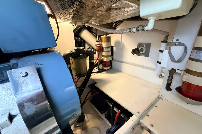 Slide: The Image of Engine room of a 1995 Tiara Yachts 4000 Express, showcasing mechanical components and filters. - 62