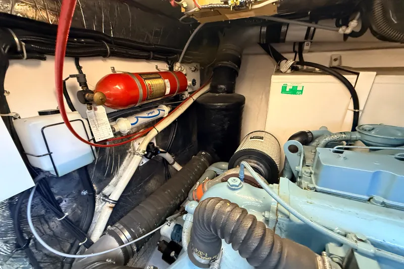 Slide: The Image of Engine room of a 1995 Tiara Yachts 4000 Express with fire extinguisher and mechanical components. - 65