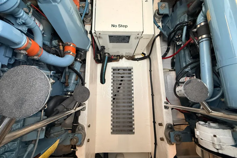 Slide: The Image of Engine room of a 1995 Tiara Yachts 4000 Express, featuring mechanical components and "No Step" sign. - 66
