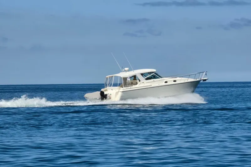 Slide: The Image of 1995 Tiara Yachts 4000 Express cruising on open blue water. - 8