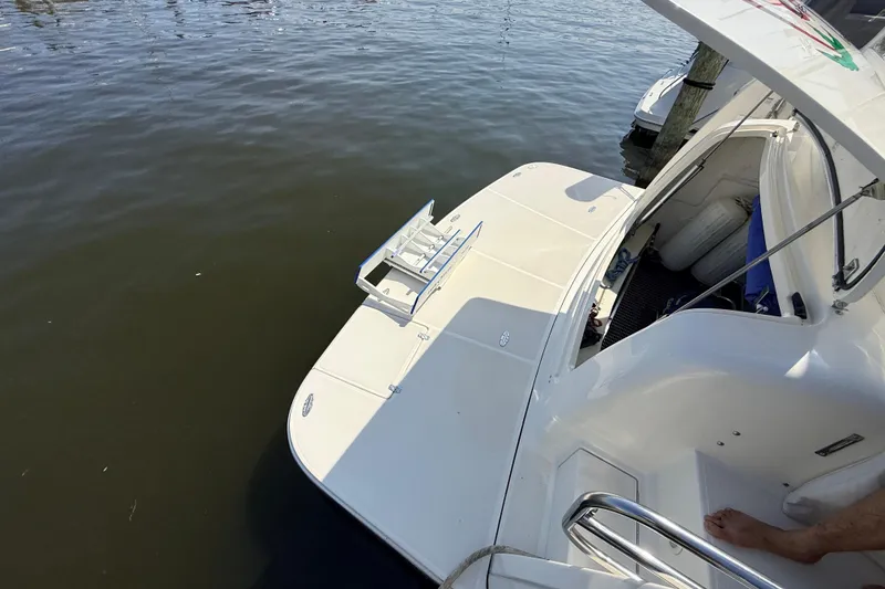 Slide: The Image of 1995 Tiara Yachts 4000 Express at dock, showing swim platform and open hatch. - 9
