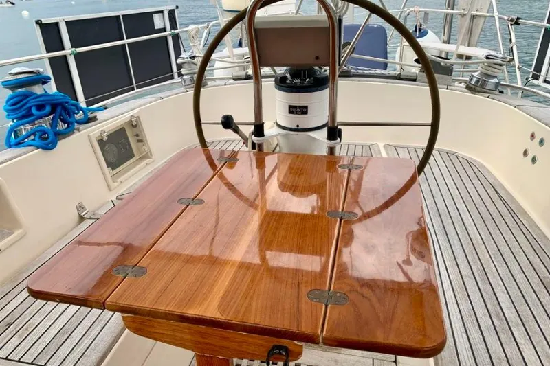 Slide: The Image of Cockpit of 1997 Hallberg-Rassy 39 sailboat with polished wooden table and steering wheel. - 10