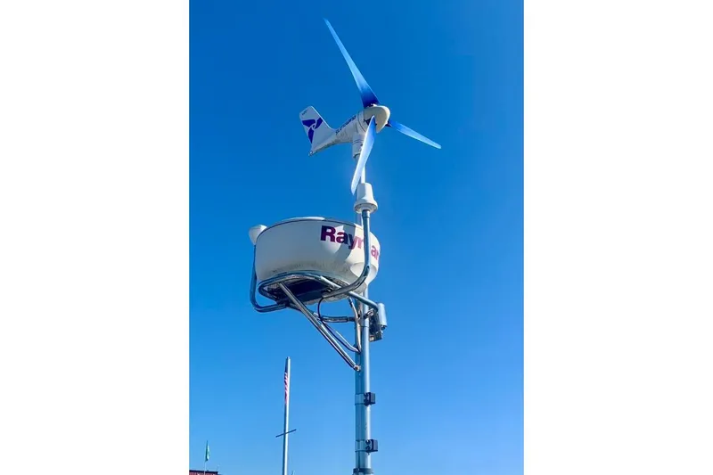 Slide: The Image of Wind turbine and radar on Hallberg-Rassy 39 yacht, 1997 model, against clear blue sky. - 11