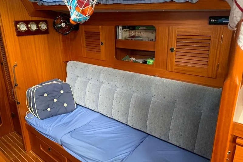Slide: The Image of Cozy interior of 1997 Hallberg-Rassy 39 sailboat with wooden cabinetry and cushioned seating. - 15