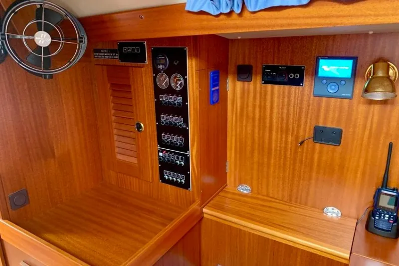 Slide: The Image of Interior of a 1997 Hallberg-Rassy 39 yacht with control panels and wooden finish. - 17