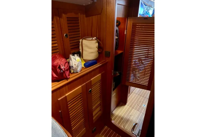 Slide: The Image of Interior of 1997 Hallberg-Rassy 39 sailboat with wooden cabinetry and storage. - 19