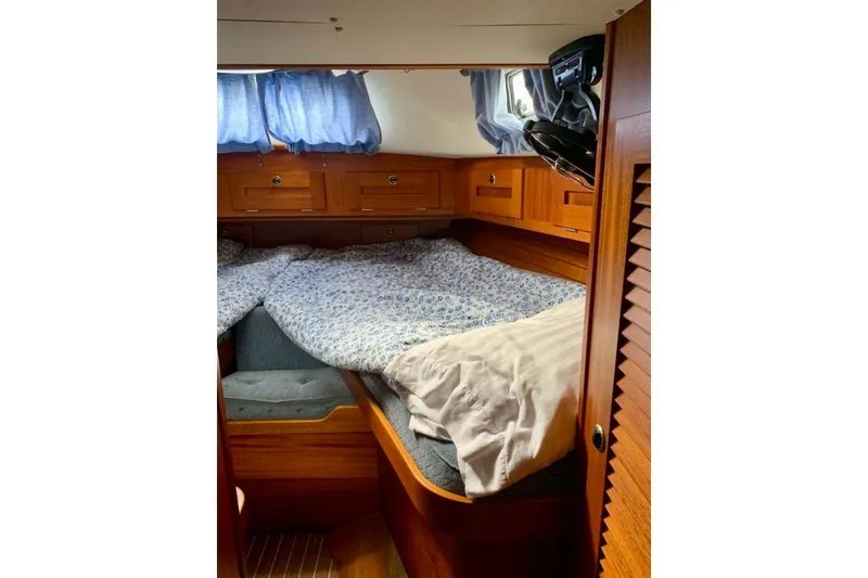 Slide: The Image of Cozy cabin interior of a 1997 Hallberg-Rassy 39 sailboat with wooden furnishings. - 20