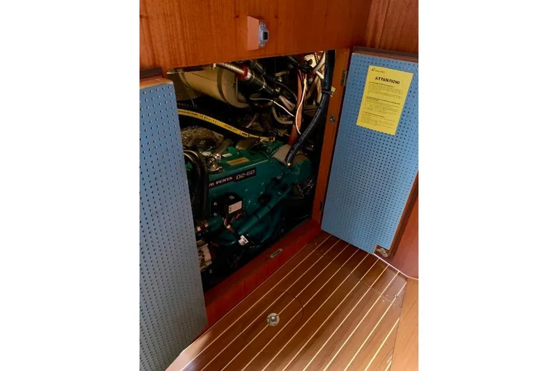 Slide: The Image of Engine compartment of a 1997 Hallberg-Rassy 39 sailboat, featuring a Volvo Penta D2-60 engine. - 25