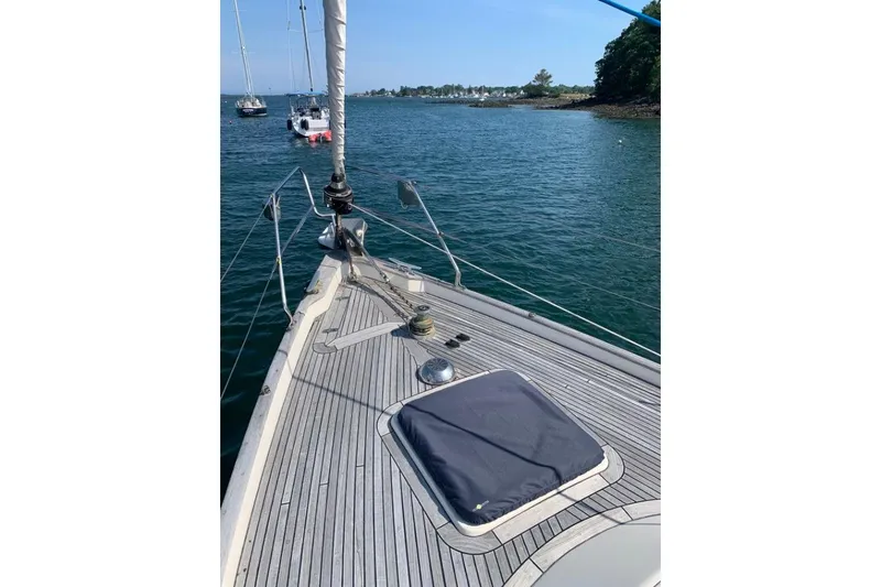 Slide: The Image of Sailing yacht Hallberg-Rassy 39, 1997 model, on calm waters with scenic shoreline. - 4