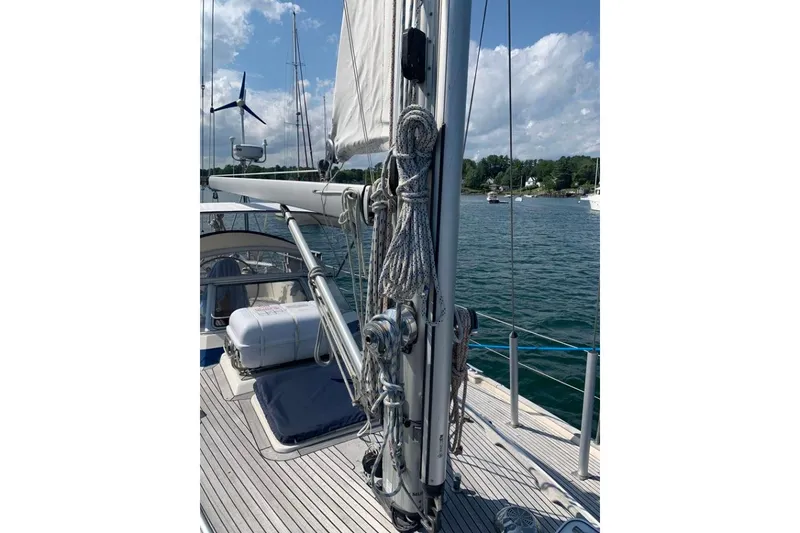 Slide: The Image of 1997 Hallberg-Rassy 39 sailboat deck with rigging and wind turbine, moored on a sunny day. - 5