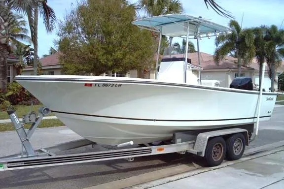 The Image of 2001 Sea Craft Master Angler 21 boat on trailer, parked in residential area. - 0
