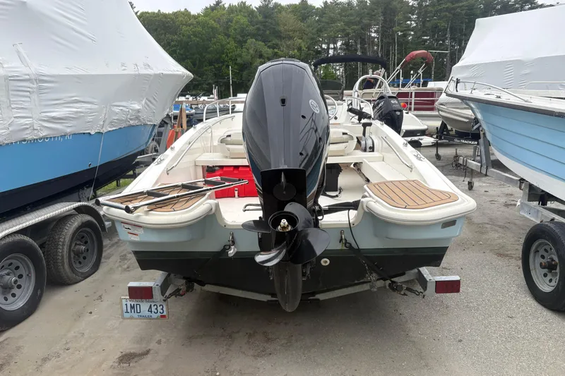 Slide: The Image of 2023 Boston Whaler 160 Super Sport boat with outboard motor, parked on a trailer. - 3