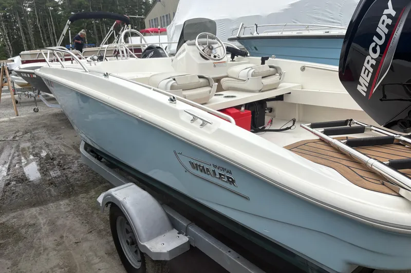 Slide: The Image of 2023 Boston Whaler 160 Super Sport boat on trailer, featuring Mercury engine. - 4