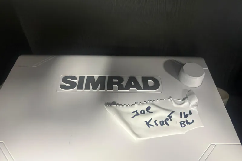 Slide: The Image of Simrad equipment on 2023 Boston Whaler 160 Super Sport boat, with handwritten note. - 9