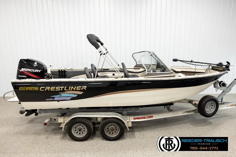 The Image of 2004 Crestliner 2050 Sportfish boat on trailer, featuring Mercury OptiMax engine. - 1