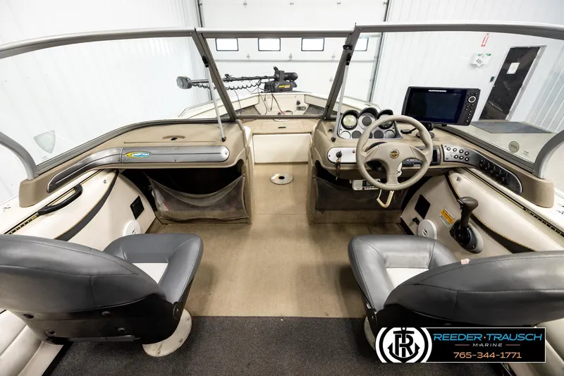 Slide: The Image of Interior view of a 2004 Crestliner 2050 Sportfish boat with steering console and seating. - 13